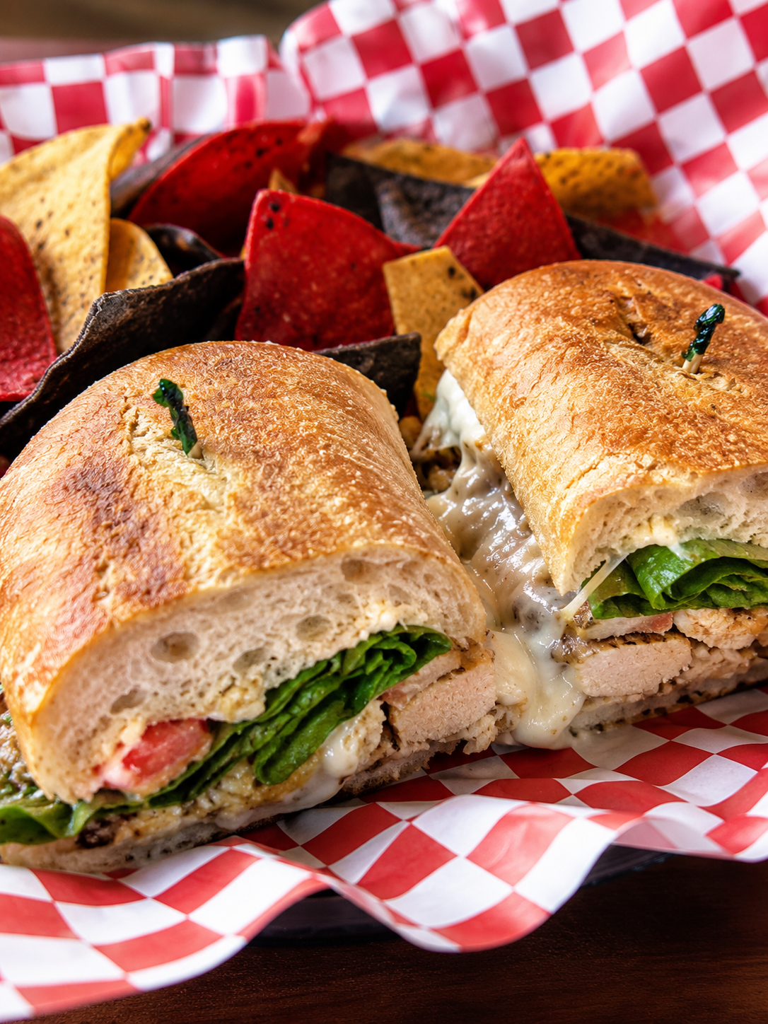 Classic ciabatta sandwich with melty cheese and multicolor tortilla chips